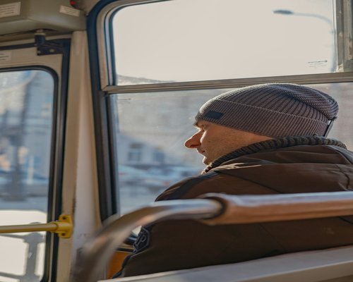 Person commuting on a public bus looking relaxed